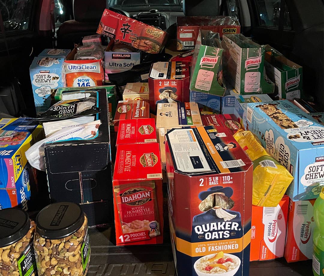 Car trunk filled with endurance fuel like Quaker Oats, granola abars, and nuts
